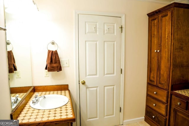 bathroom with vanity and ornamental molding