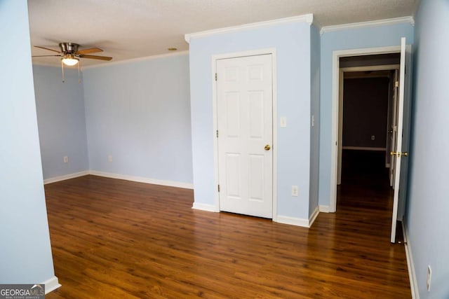 spare room with ceiling fan, ornamental molding, and dark hardwood / wood-style flooring