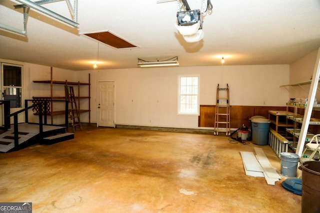 garage with wooden walls and a garage door opener