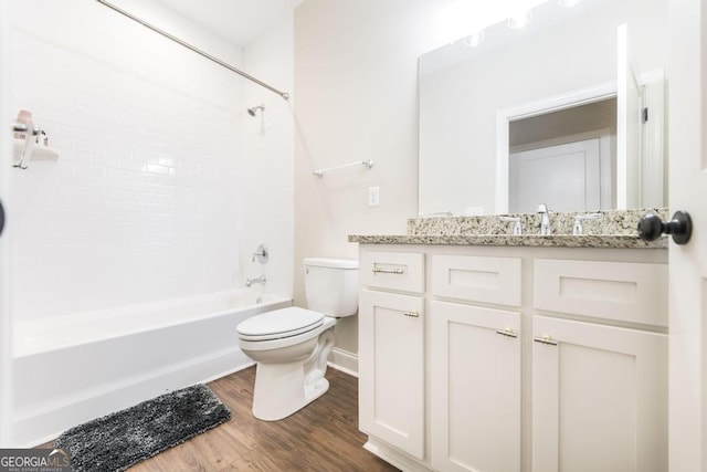 full bathroom with shower / bath combination, hardwood / wood-style floors, toilet, and vanity