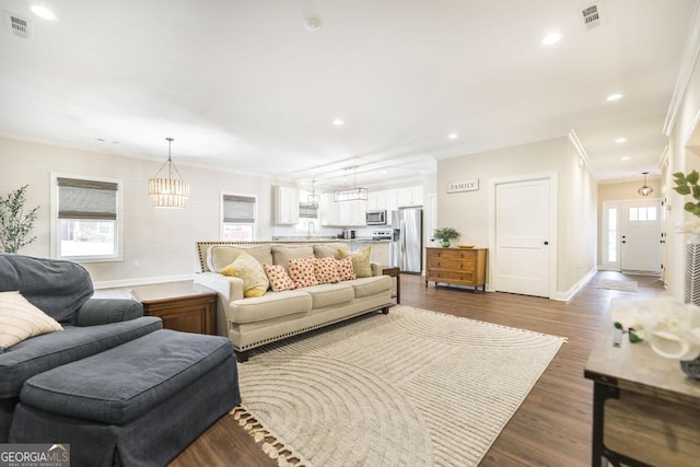 living room featuring crown molding and dark hardwood / wood-style flooring