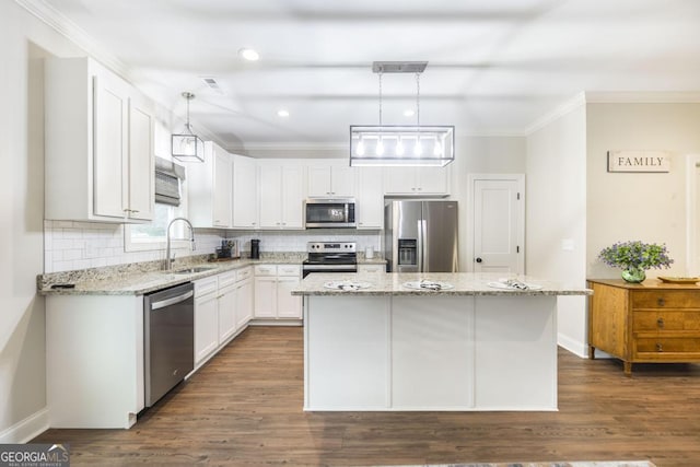 kitchen featuring pendant lighting, a center island, white cabinets, and appliances with stainless steel finishes