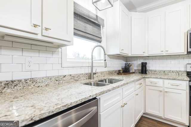 kitchen featuring tasteful backsplash, white cabinetry, sink, stainless steel appliances, and light stone counters