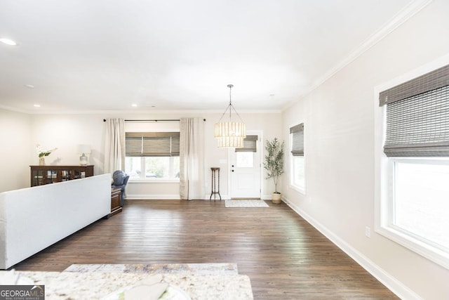 unfurnished living room featuring ornamental molding and dark hardwood / wood-style floors