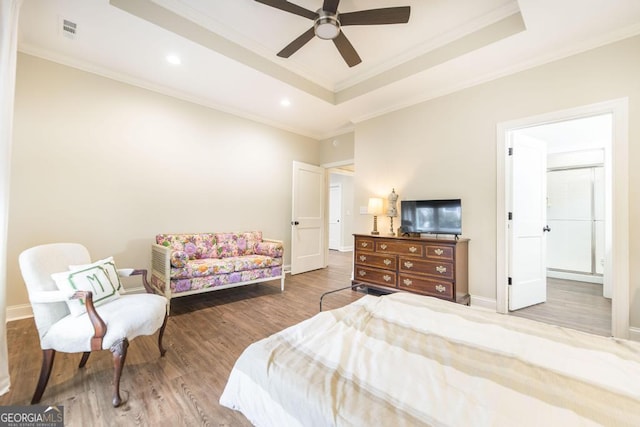 bedroom with ceiling fan, a raised ceiling, and crown molding