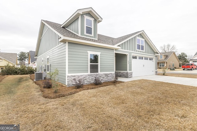 craftsman-style house with central air condition unit and a front lawn