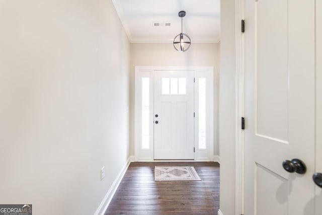 foyer entrance featuring dark hardwood / wood-style floors and ornamental molding