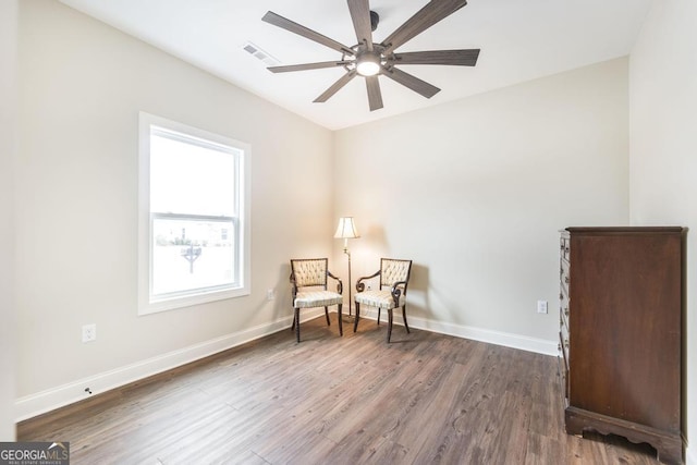 sitting room featuring ceiling fan and dark hardwood / wood-style flooring