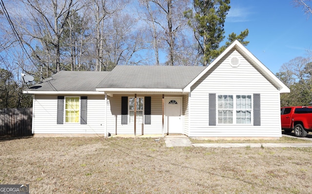 single story home with a front lawn and covered porch