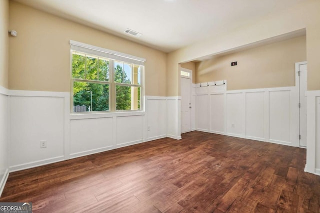 spare room featuring dark wood-type flooring