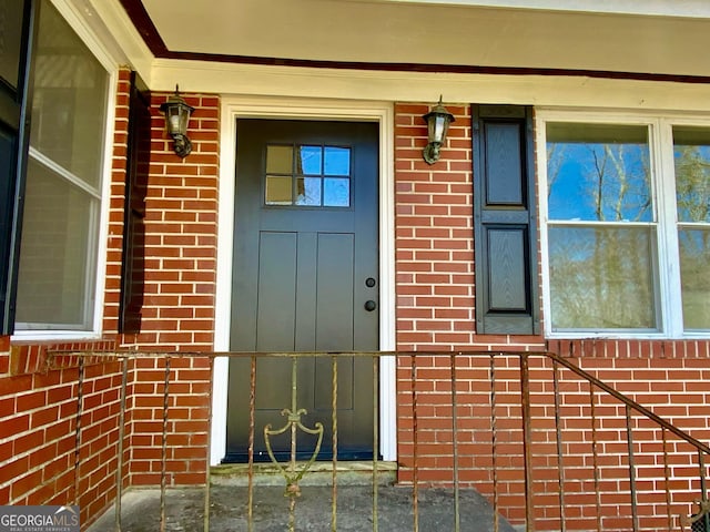 property entrance with brick siding