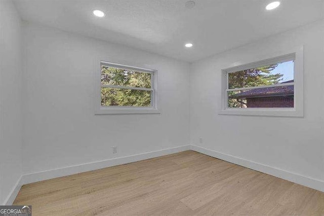 spare room with light hardwood / wood-style flooring