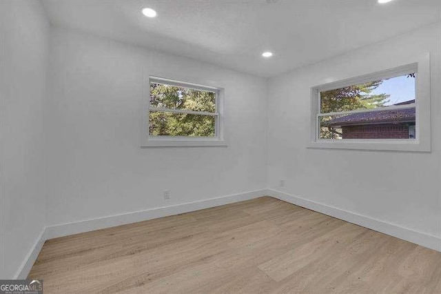 spare room featuring light hardwood / wood-style floors