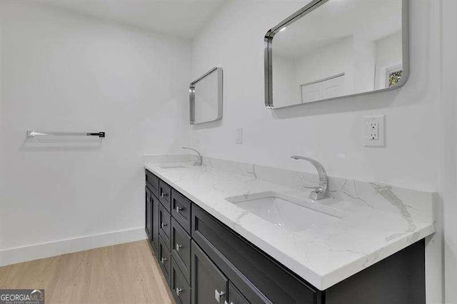 bathroom with vanity and wood-type flooring