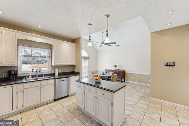 kitchen with dishwasher, white cabinetry, sink, vaulted ceiling, and ceiling fan