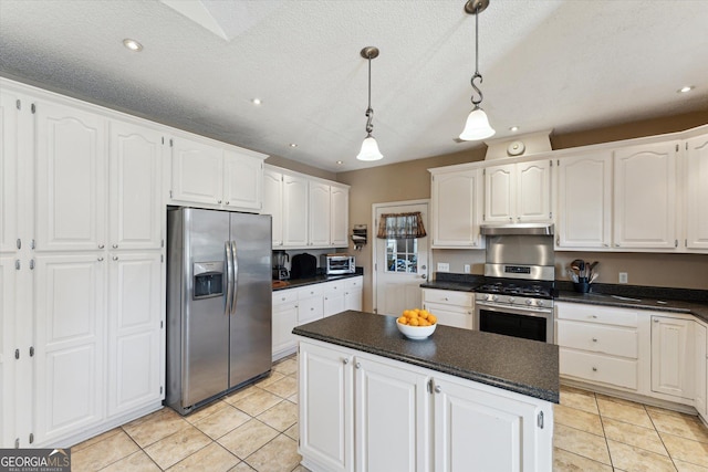 kitchen with light tile patterned floors, appliances with stainless steel finishes, pendant lighting, and white cabinets