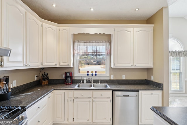 kitchen featuring sink, white cabinetry, appliances with stainless steel finishes, and a wealth of natural light