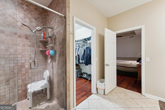 bathroom featuring tile patterned floors and a shower with door