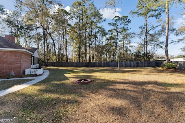 view of yard with a fire pit