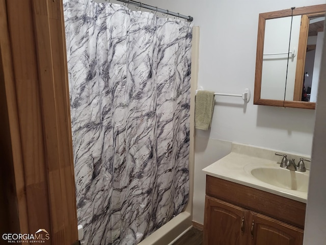 bathroom with vanity and curtained shower