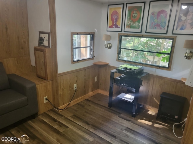 office area with wood walls and dark hardwood / wood-style floors