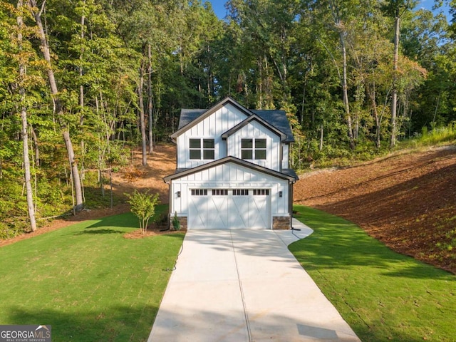 view of front of home with a front lawn and a garage