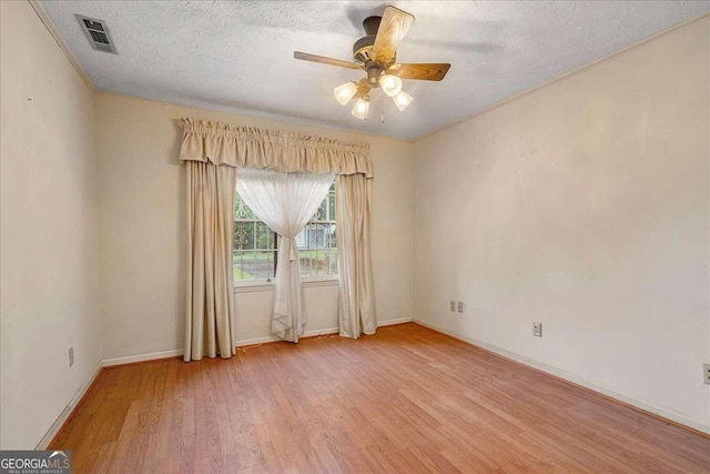 unfurnished room with a textured ceiling, ceiling fan, and light hardwood / wood-style floors