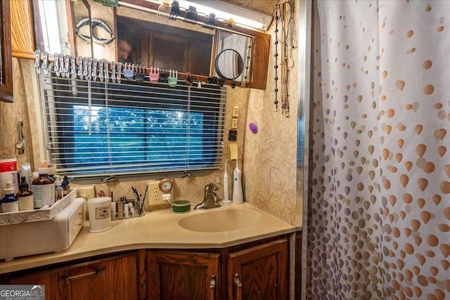 bathroom with walk in shower and vanity