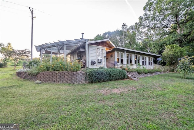 rear view of house featuring a yard