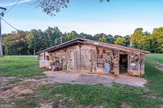 view of outbuilding with a lawn