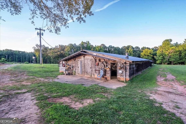 view of outbuilding featuring a lawn