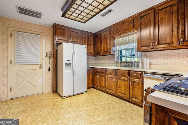 kitchen with sink and white fridge with ice dispenser