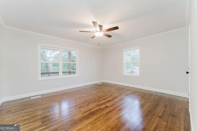 empty room featuring ceiling fan, dark hardwood / wood-style floors, and crown molding