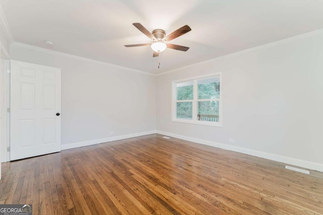 spare room featuring ceiling fan, hardwood / wood-style floors, and crown molding