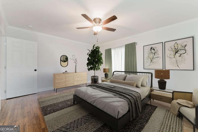 bedroom featuring ceiling fan, wood-type flooring, and ornamental molding