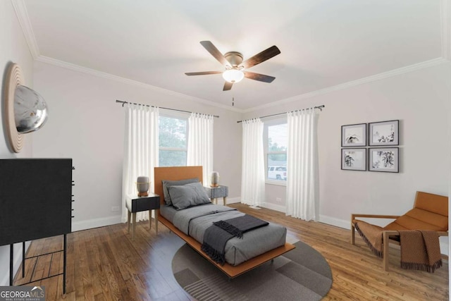 bedroom featuring ceiling fan, wood-type flooring, and ornamental molding