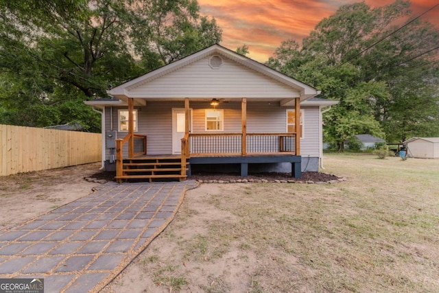 bungalow featuring a wooden deck and a yard