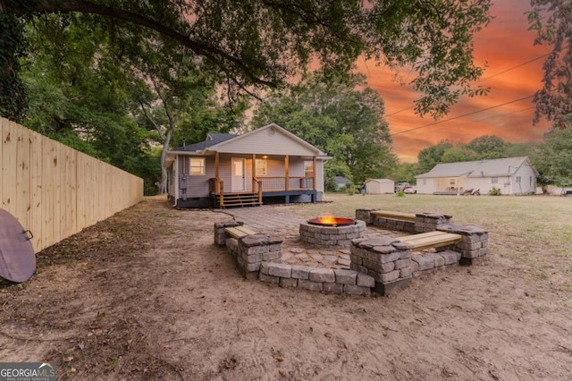 exterior space with an outdoor fire pit and a shed