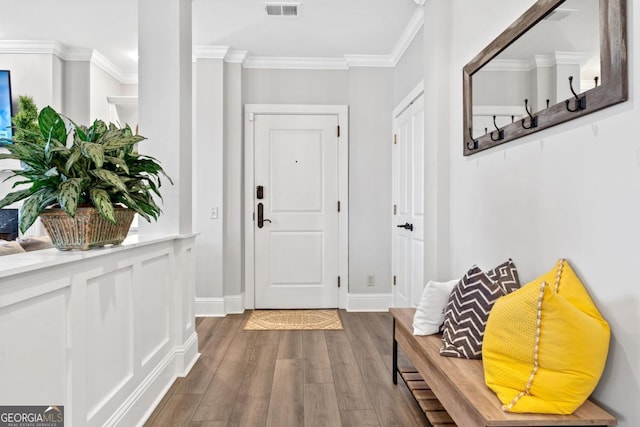 interior space with ornamental molding and hardwood / wood-style flooring