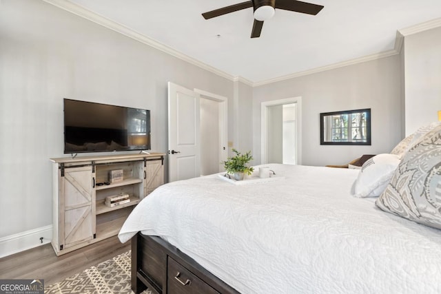 bedroom featuring ceiling fan, dark hardwood / wood-style floors, and ornamental molding