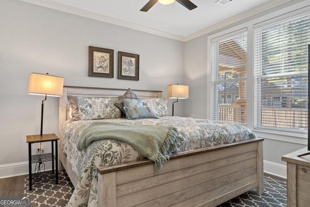 bedroom with ceiling fan, dark hardwood / wood-style flooring, crown molding, and multiple windows