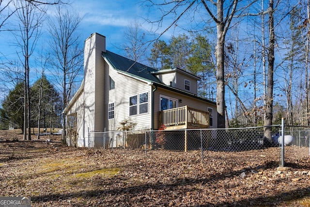 view of property exterior with a wooden deck