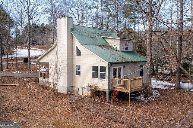 snow covered property with a deck