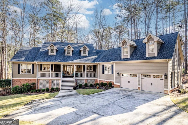 cape cod house with a garage, a front lawn, and a porch