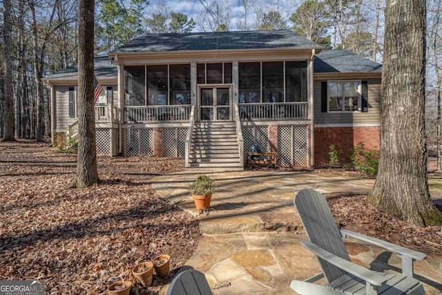 back of house with a sunroom