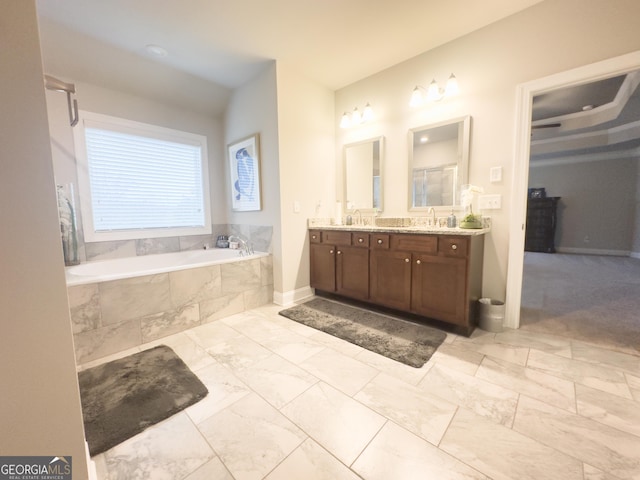 bathroom with tiled bath and vanity