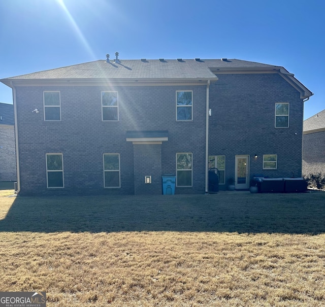 rear view of property with a yard