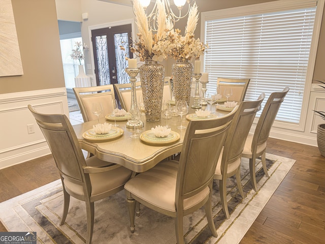 dining room with dark wood-type flooring and a chandelier