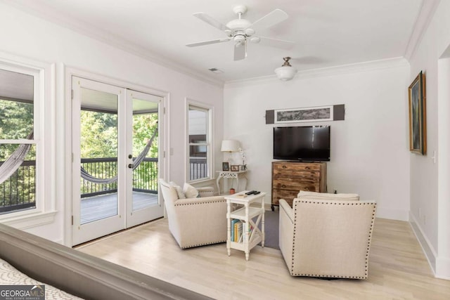 living room featuring light hardwood / wood-style floors, french doors, crown molding, and ceiling fan