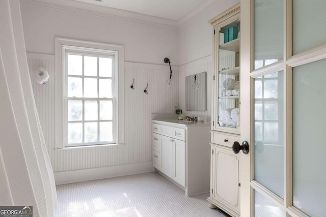 bathroom with vanity and ornamental molding